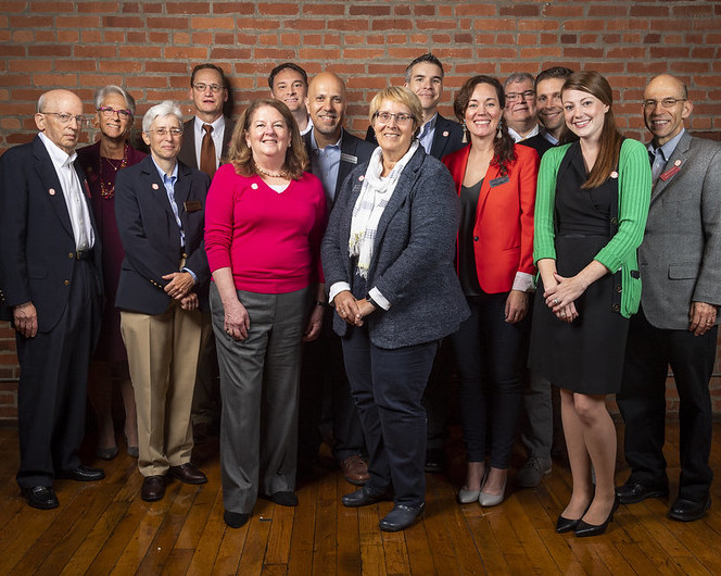 group of mha alumni gather for photo