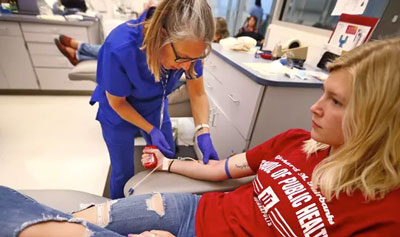 public health student giving blood