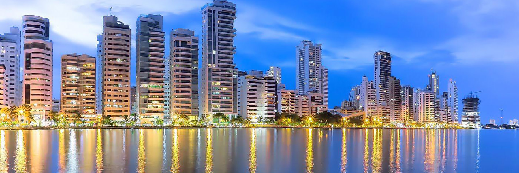 buildings in cartagena reflecting off water at night