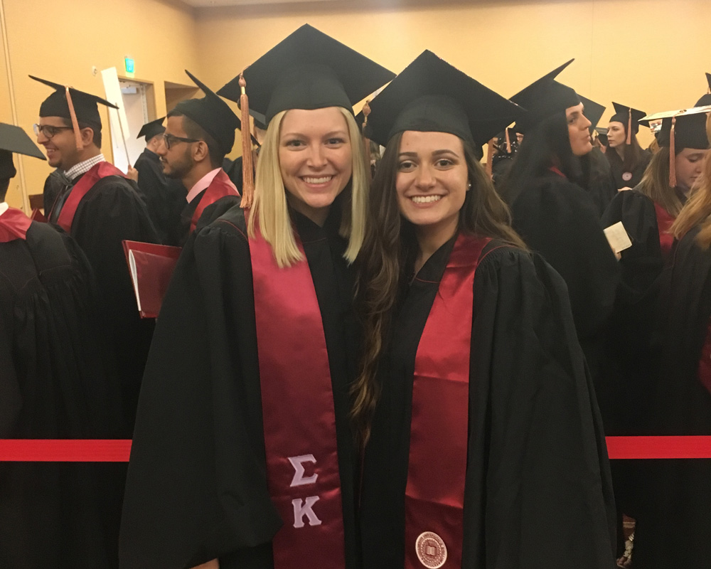 two fsph graduates at graduation ceremony