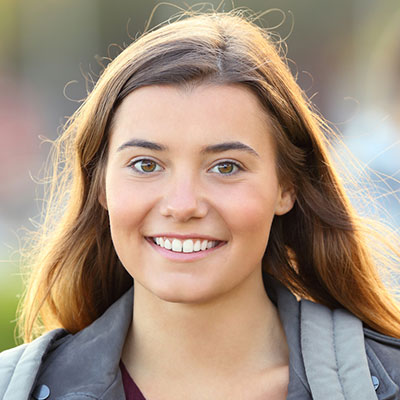 smiling student carrying backpack