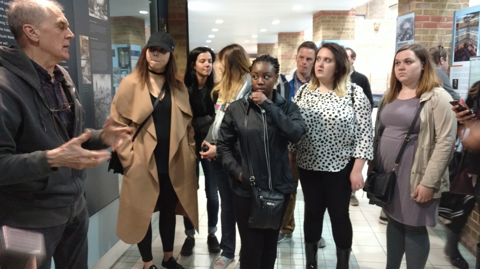 Study abroad students in London listening to speaker on field trip