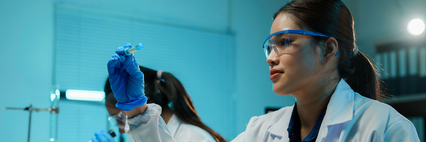 Team of scientists wearing lab coats, conducting research in a laboratory setting, analyzing test tubes