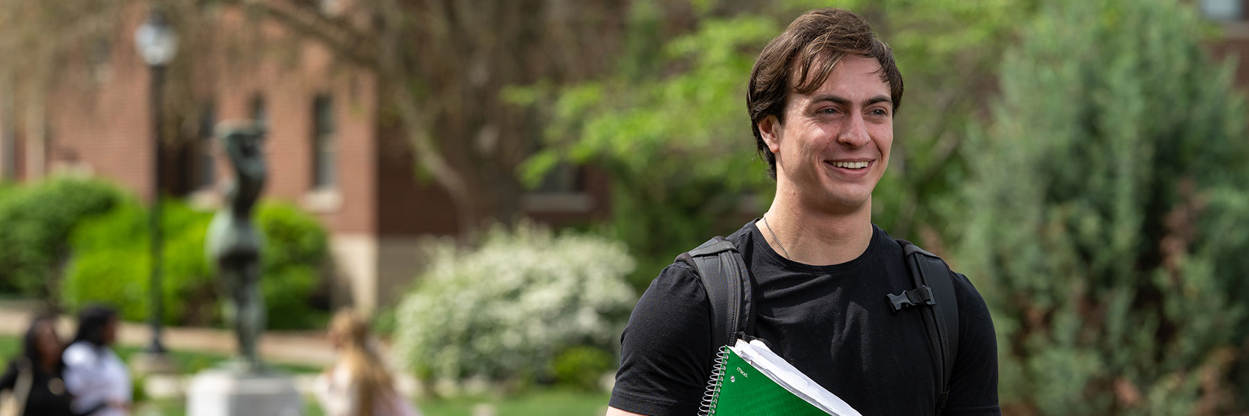 male student walking on campus