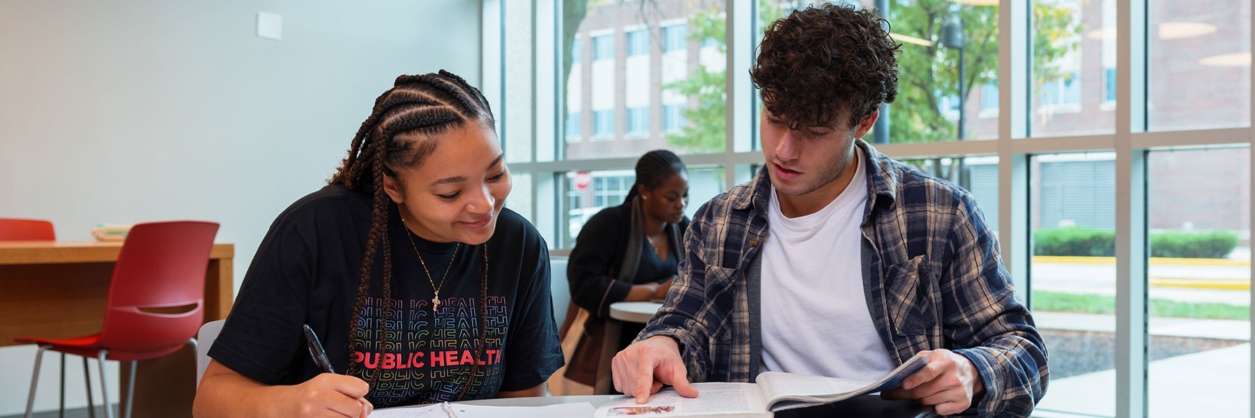 two public health students studying together in the health sciences building