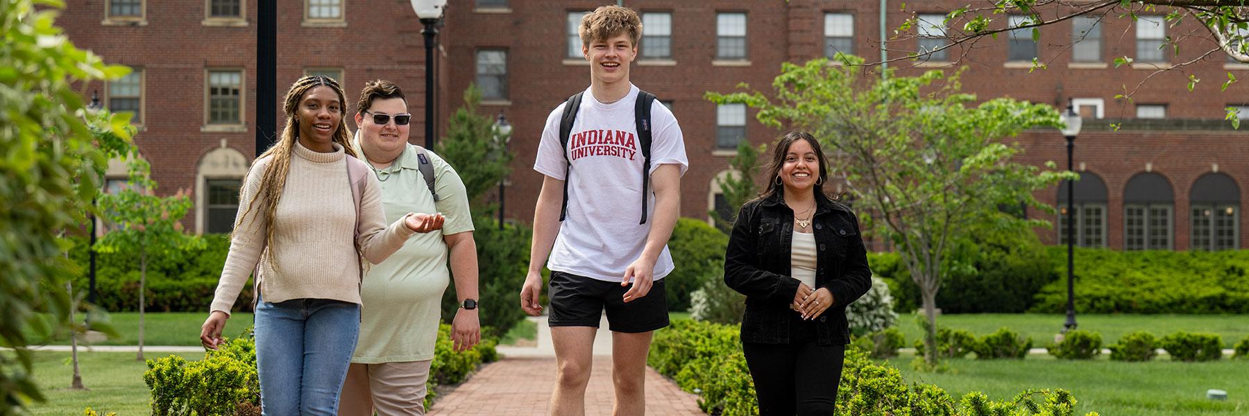 four students walking on campus