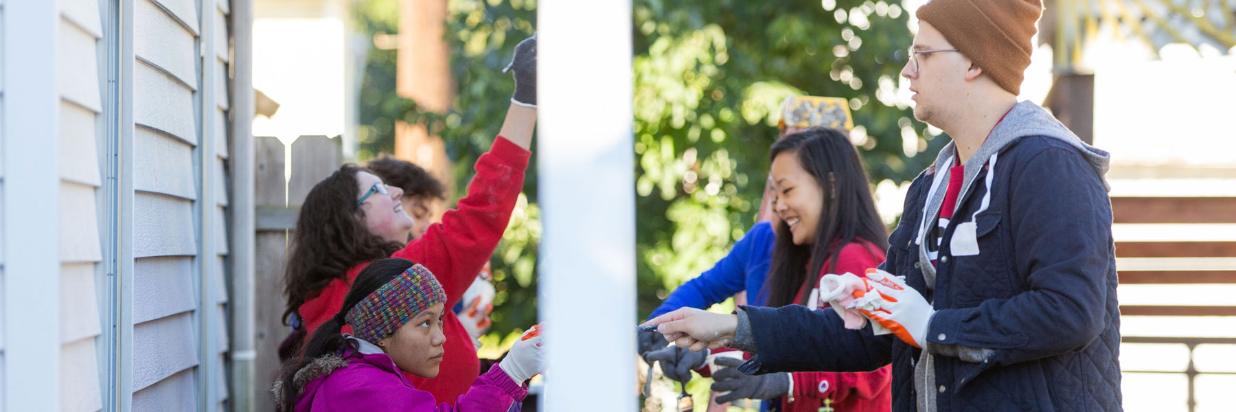 volunteers painting a house