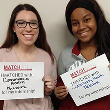 students display their match signs at interview day