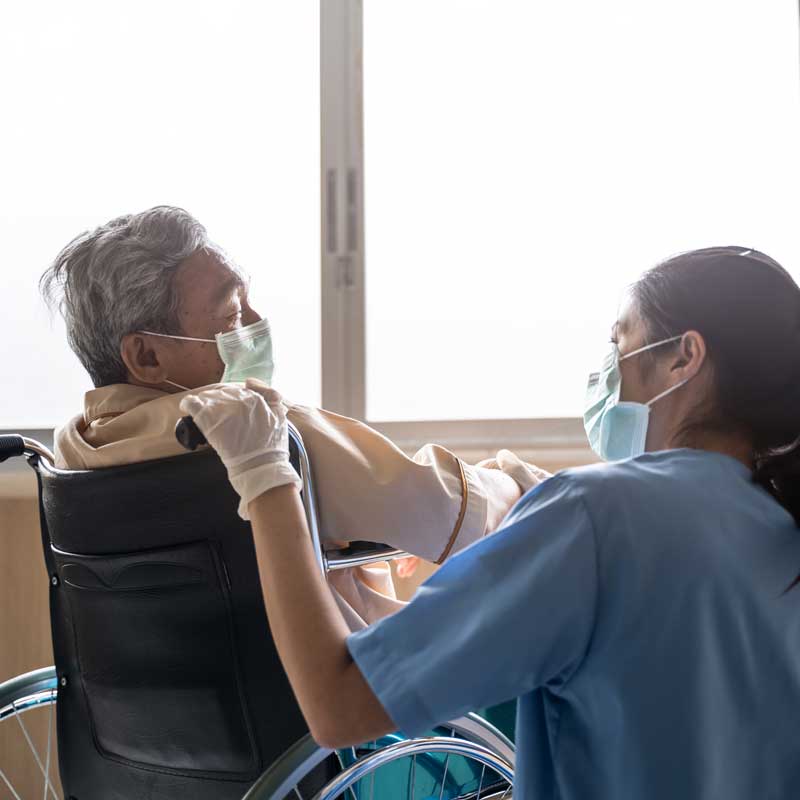 nurse tending to patient in wheelchair