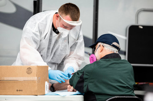 health care worker giving test to patient