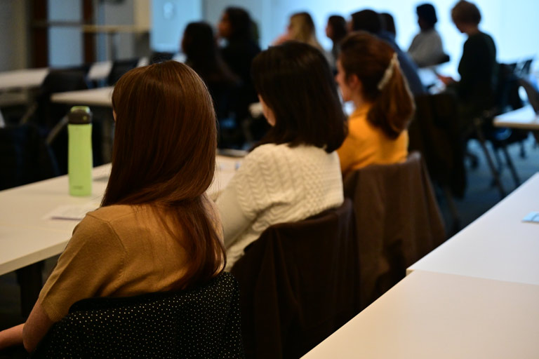 attendees listen to seminar presentation