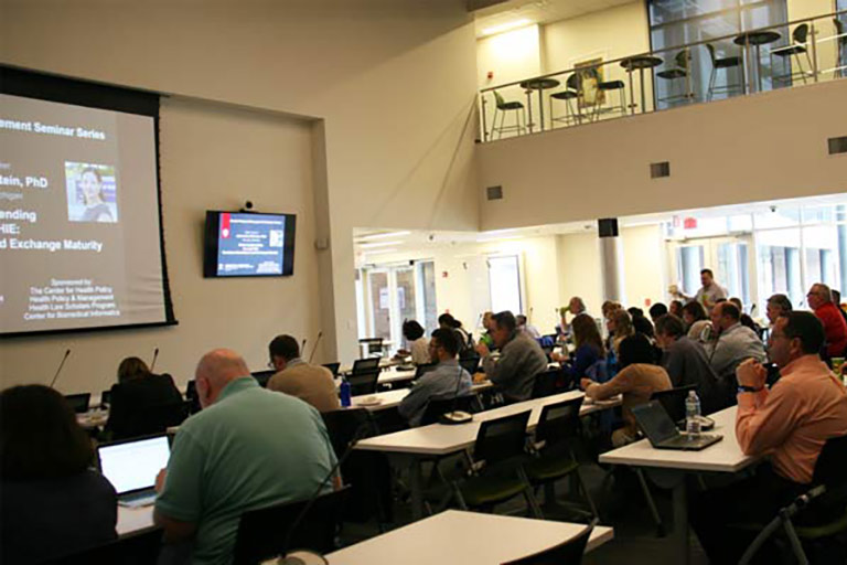 attendees listen during seminar presentation 