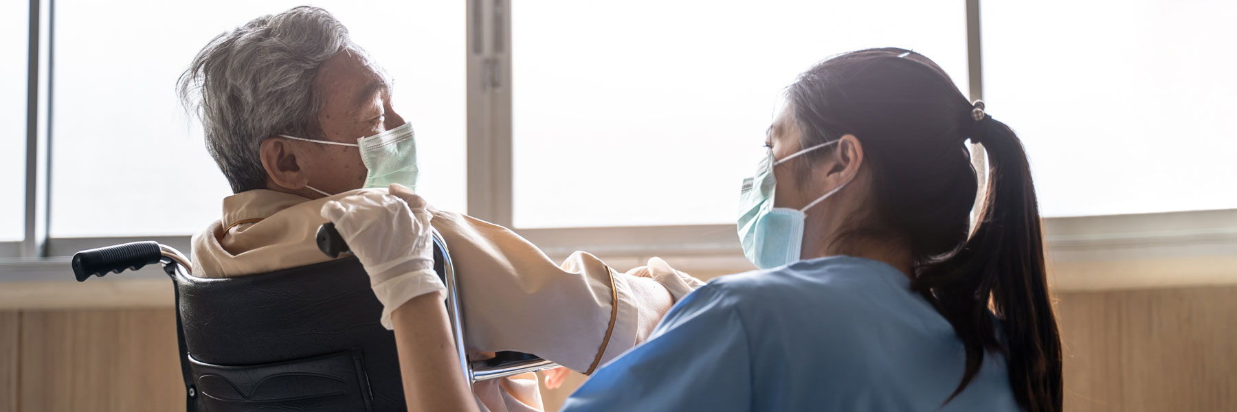 nurse talking to patient in wheelchair